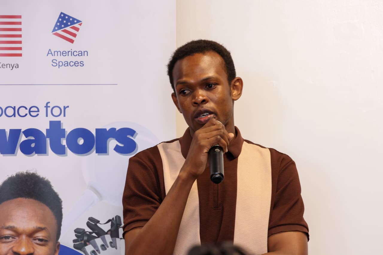 Teddy Jeremy speaking into a microphone at an American Spaces event